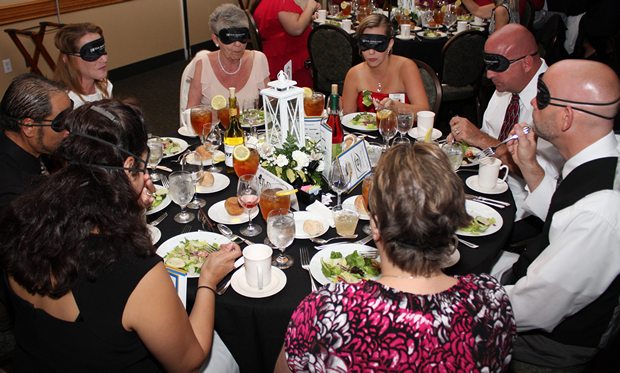 Blindfolded diners at dining in the dark